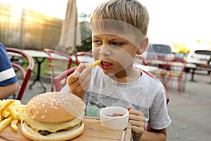 Boy eating fries with ketchup