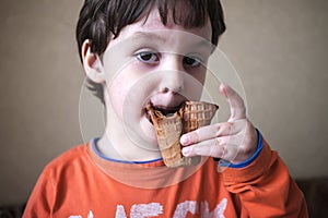 The boy is eating ice cream.