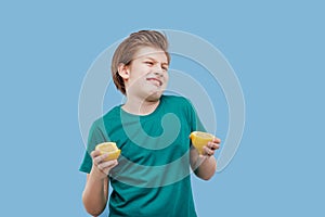 Boy eating a lemon, sour taste, make grimace,