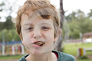 Boy eating meatballs with mouth full