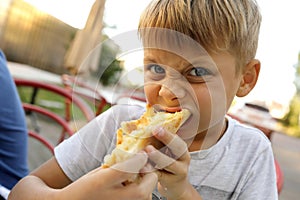 Boy eating Megrelian Khachapuri