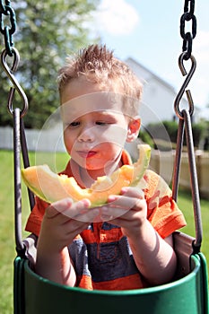 Boy eating melon