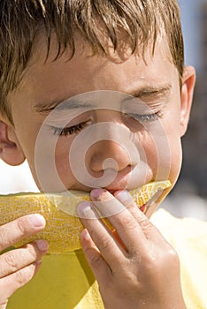 Boy eating melon