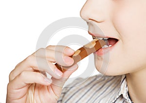 Boy eating milk chocolate bar