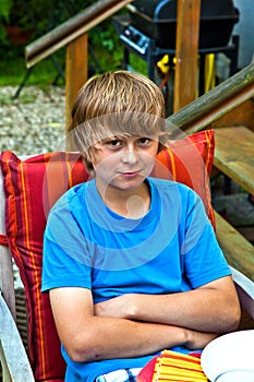 Boy eating outside at a table