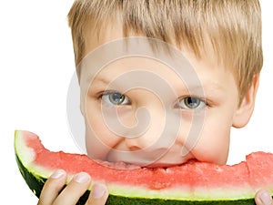 Boy eating a piece of watermelon