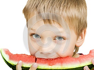Boy eating a piece of watermelon