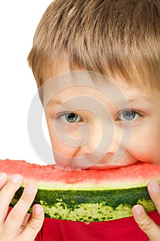 Boy eating a piece of watermelon
