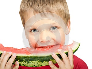 Boy eating a piece of watermelon