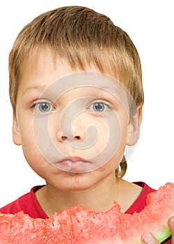 Boy eating a piece of watermelon