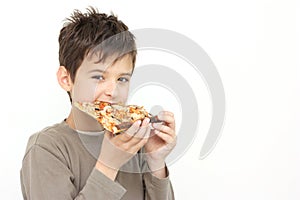 A boy eating pizza photo