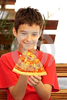 A boy eating pizza photo