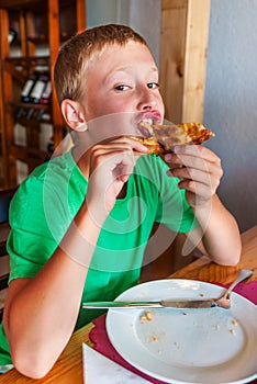 Boy eating pizza