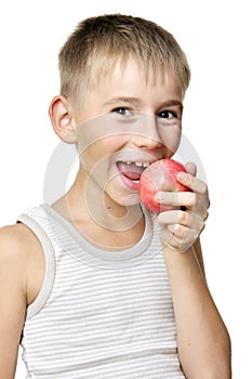 Boy eating red apple