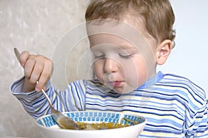 Boy eating soup