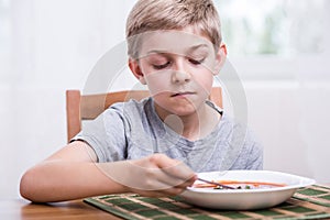 Boy eating soup