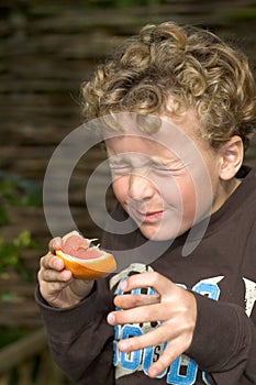 Boy eating Sour Grapefruit