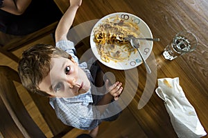 Boy eating spaghetti