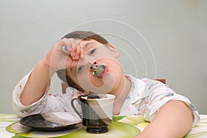 Boy eating with spoon