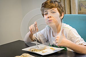 Boy eating traditional polish dumplings