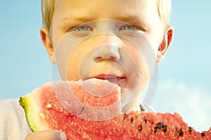 Boy eating watermelon slice