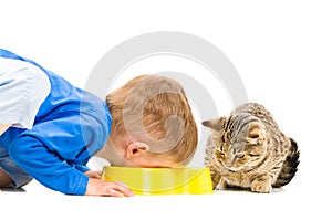 Boy eats a bowl of cat photo
