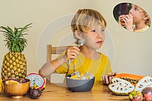 Boy eats fruit but dreams about hamburger. Harmful and healthy food for children. Child eating healthy snack. Vegetarian