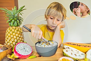 Boy eats fruit but dreams about hamburger. Harmful and healthy food for children. Child eating healthy snack. Vegetarian