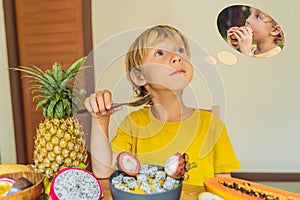 Boy eats fruit but dreams about hamburger. Harmful and healthy food for children. Child eating healthy snack. Vegetarian