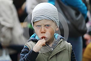 The boy eats lollipop