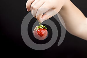 a boy eats strawberries