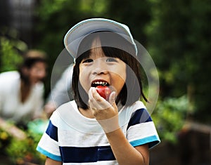 A boy eatting tomato photo