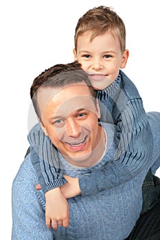 Boy embraces father behind