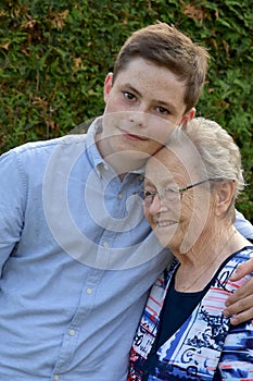 Boy embraces lovingly his great-grandma