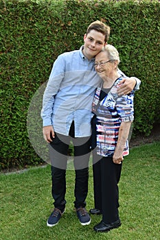 Boy embraces lovingly his great-grandma