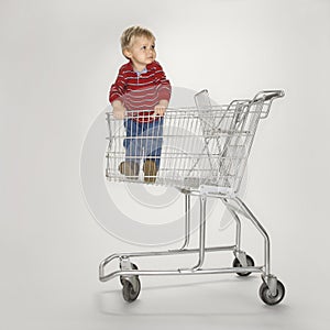 Boy in empty cart.