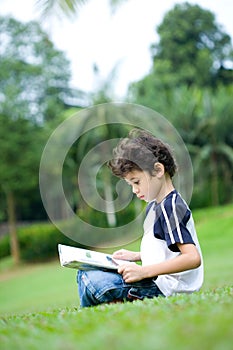 Boy engross in reading his book
