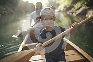 Boy enjoy canoeing time with his father