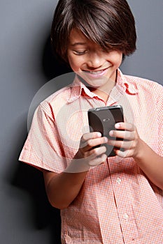 Boy enjoy playing a mobilephone