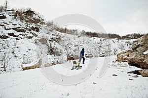 Boy enjoy a sleigh ride. Child sledding. Kid riding a sledge on winter