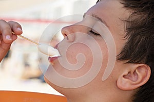 A Boy Enjoying a Vanilla Ice lolly