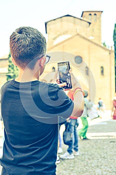 Boy enjoying the view of Saint Stephen church at Bologna .