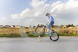 Boy enjoys jumping with his dirtbike photo