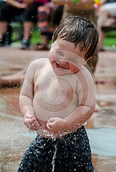 Boy enjoys a summer fountain