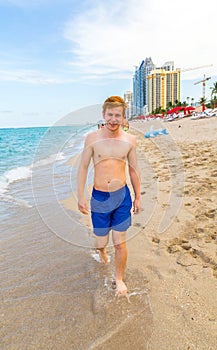 Boy enjoys walking along the beach