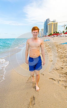 Boy enjoys walking along the beach