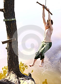 Boy entertain themselfs with water swing on vacation photo