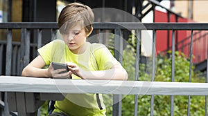 Chlapec hraje hra na jeho mobilní telefon. školák v jeho ruky hodinky videa chatování 