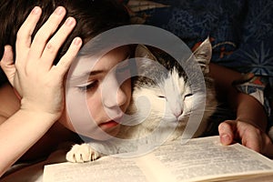 Boy evening read book with cat