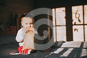 Boy examines a bag of Christmas gifts